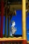 View on golden pillars, drum and white buddha statue against blue sky at Buddhist temple - Wat Ek Phnom, near Battambang, Cambodia