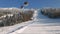 View of gondola lift with snow covered mountains, gondola above ski slope