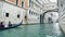 View of gondola on water under the Bridge of Sighs, rainy day