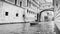 View of gondola on water under the Bridge of Sighs in Venice. Black and white
