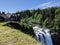 View of the gorgeous Snoqualmie Falls with Salish Lodge and Spa in the background, on a beautiful summer day