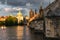 View on gothic Old Town Bridge Tower and Charles bridge over Vltava river under storm clouds