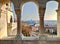 View on the gothic parliament of Budapest through the columns of the Fisherman`s Bastion