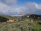 View of Gran Canaria landscape from a hill with Galdar town, Montana de Ajodar, red roof country house and winding road
