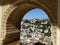 View of Granada through Islamic arch at the Nazarene Palaces, Alhambra, Granada