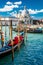 View of Grand Canal in Venice with colorful gondola boats in the foreground