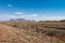 View of grassland and hills with fence and railway tracks in South Africa