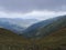 View from grassy hill slopes of hiking trail from Chopok at mountain meadow ridge Low Tatras mountains, Slovakia. Fog