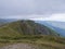 View from grassy hill slopes of hiking trail from Chopok at mountain meadow ridge Low Tatras mountains, Slovakia. Fog