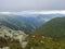 View from grassy hill slopes of hiking trail from Chopok at mountain meadow ridge Low Tatras mountains, Slovakia. Fog