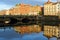 View of Grattan Bridge in Dublin, Ireland, with building reflections in the Liffey river