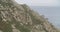 View of a great formation of rocks near the sea with a boat sailing in the horizon