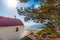 View of Greek orthodox church with cyclamen roof next to forest Rhodes, Greece