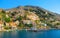 View on Greek sea Symi island harbor port, classical ship yachts, houses on island hills, tourists Aegean Sea bay. Greece islandsV