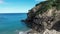 View of the green cliffs and blue sea from a drone.