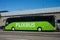 View of green flixbus in rton of the train station in the street, flixbus is the famous intercity travel company