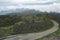 View of green hills and trees. Views of mountains and buildings The view of the road cuts through the natural route.