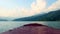 View of green mountains from the nose of a floating boat