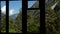 View of the green mountains from the window of an abandoned building. The camera shakes.