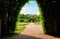 View through the green pergola into the palace gardens of Schwerin with a blue sky