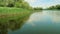 View of green reeds and birch trees on rover shore. View from nose of boat floating on river. Beauty of Russian nature.