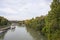 View of the green rive Tiber in Rome looking from the bridge