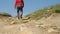 View from ground level of man walking rugged road of Nebrodi Park,