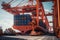 View from the ground to a huge port crane loading container ship. Tractors and loading platforms involved in the loading