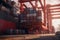 View from the ground to a huge port crane loading container ship. Tractors and loading platforms involved in the loading