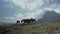 View of a group of horses grazing grass along the Lake Ayous in the Pyrenees in France on a bright sunny morning.