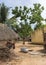 View through a group of humble dwellings in village.