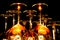 View on group of isolated red yellow shiny glowing wine glasses in cupboard