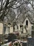 View into group of Montmartre Cemetery tombs under a winter sky