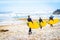 View on group of surfer at the beach of Ribeira d`Ilhas next to Ericeira, Portugal