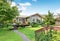 View of guest house with wooden deck and nicely trimmed garden