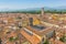 A view from the Guinigi Tower over the terracotta roofs towards towers in Lucca, Italy