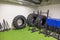 View of gym with roll-over tires for strongman training and various other sports equipment for active sports workout.