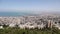 View of Haifa from the mountain. Residential buildings, streets, roads, port, sea.