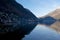 View Hallstatt town in winter under the shadow of mountain behind it.