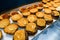 view of hamburger bun halves anointed with ketchup and mustard, served with cutlets and a slice of cheese