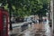 View of Hampstead High Street in the rain, people walk on background, London, UK