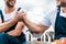 View of handymen holding hands against sky with clouds