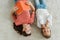 View of happy babysitter holding book while looking at kid lying on carpet