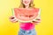 View of happy girl with watermelon On yellow