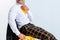 View of happy man in checkered trousers sitting on white