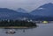 View of the harbor, Stanley Park and the mountains with floating fuel station and barge with sulfur in Vancouver, Canada