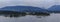 View of the harbor, Stanley Park and the mountains with floating fuel station and barge with sulfur in Vancouver, Canada