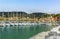 A view from the harbour breakwater of boats moored in the bay in front of the town at Lerici, Italy