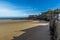 A view from the harbour wall towards the Castle Hill and the lifeboat stations in Tenby bathed in sunshine at low tide