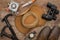 View of hat, boots, hiking poles, binoculars, jackknife and gas-burner on wooden surface